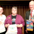DG Margaret Taylor exchanging banners with John Balshaw and Amy Connors